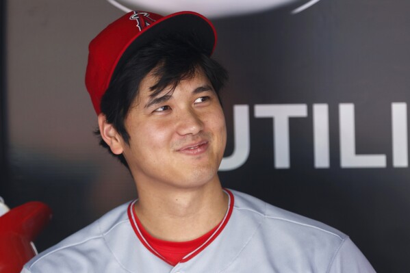 FILE - Los Angeles Angels designated hitter Shohei Ohtani looks on from the dugout ahead of a baseball game against the Toronto Blue Jays in Toronto, Sunday, July 30, 2023. Shohei Ohtani has been named The Associated Press' Male Athlete of the Year for the second time in three years. (Cole Burston/The Canadian Press via AP, File)