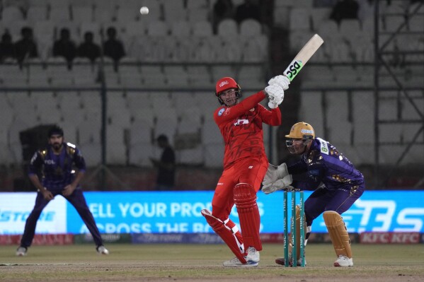 Islamabad United' Alex Hales, center, plays a shot during the Pakistan Super League T20 cricket eliminator match between Islamabad United and Quetta Gladiators, in Karachi, Pakistan, Friday, March 15, 2024. (AP Photo/Fareed Khan)