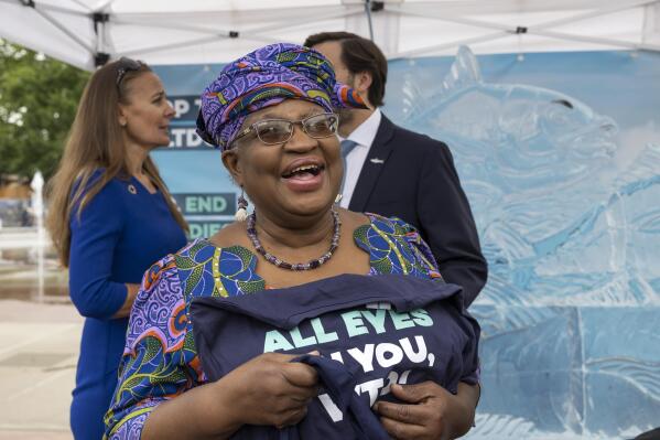 Nigeria's Ngozi Okonjo-Iweala, Director General of the World Trade Organisation (WTO), attends an event on World Ocean Day with Finley the fish, made of ice, on place des Nations before of the World Trade Organization (WTO) Ministerial Conference (MC12) where a deal to end harmful fisheries subsidies could be reached in Geneva, Switzerland, Wednesday, June 8, 2022. (Salvatore Di Nolfi/Keystone via AP)
