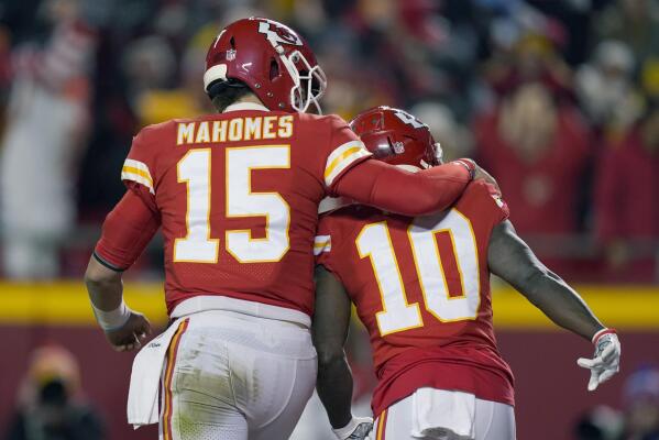 Kansas City Chiefs offensive coordinator Eric Bieniemy talks to Chiefs  tight end Travis Kelce (87) after their win over the Buffalo Bills in an NFL  divisional playoff football game, Sunday, Jan. 23