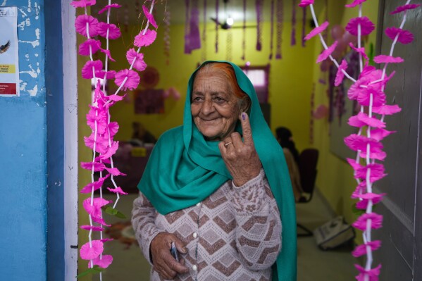 An elderly woman shows the indelible ink mark on her finger after casting vote at women only booth during the first round of polling of India's national election in Doda district, Jammu and Kashmir, India, Friday, April 19, 2024. (AP Photo/Channi Anand)