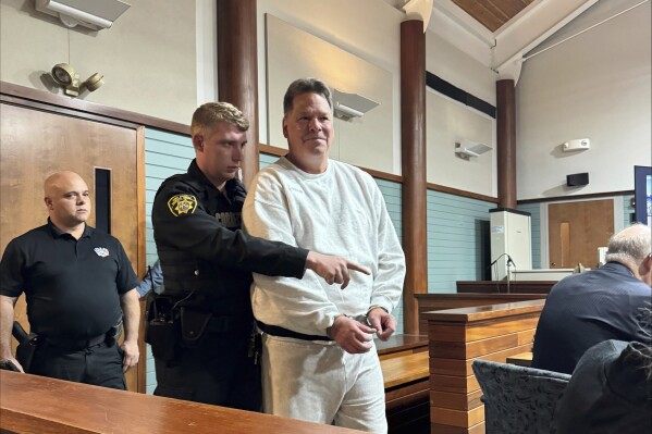 This image provided by WMTW, shows Dennis Dechaine, who's serving a life prison sentence for killing a 12-year-old girl in 1988, is seen walking into a courtroom for the start of a hearing in which his lawyer is trying to convince a judge to order a new trial based on new DNA evidence, on Thursday, April 18, 2024, in Rockland, Maine. (Connor Clement/WMTW via AP )