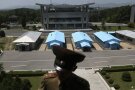 
              A South Korean building complex is seen in the background as North Korean soldiers guard the truce village at the Demilitarized Zone (DMZ) which separates the two Koreas in Panmunjom, North Korea, Wednesday, June 20, 2018. A tour guide Hwang Myong Jin, on the northern side of the Demilitarized Zone that divides the two Koreas, says that since the summits between North Korean leader Kim Jong Un and the presidents of South Korea and the United States, things have quieted down noticeably in perhaps the most iconic symbol of the one last place on Earth where the Cold War still burns hot. (AP Photo/Dita Alangkara)
            