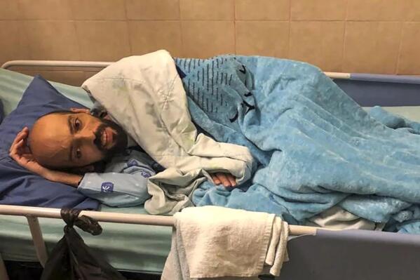 This photo provided by Ahlam Haddad, a lawyer for Khalil Awawdeh, shows Khalil Awawdeh, 40, who has been on a hunger strike for several months protesting being jailed without charge or trial under what Israel refers to as administrative detention, lies in bed at Asaf Harofeh Hospital in Be'er Ya'akov, Israel, Friday, Aug. 19, 2022. Israel's Supreme Court court rejected an appeal by his lawyer on Sunday calling for his immediate release due to his failing medical condition. Around 670 Palestinians are currently being held in administrative detention by Israel. (Ahlam Haddad, via AP)