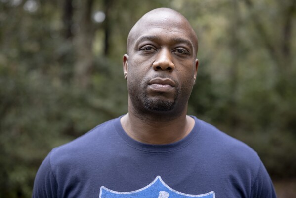 Former NFL player Boo Williams poses for a portrait outside of his home in Picayune, Miss., Wednesday, Nov. 15, 2023. Williams needs surgery, medicine and doctors to make the pain subside from injuries he endured during his football career. But he can't afford any of it. The 44-year-old was recently awarded $5,000 a month by the NFL's disability benefit plan. But Williams said the plan and the league have repeatedly mishandled his claims and should really have paid him $500,000 or more over the past 14 years. (AP Photo/Christiana Botic)