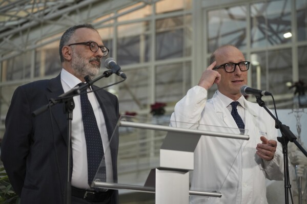 Surgeon Sergio Alfieri, right, and Pope Francis personal doctor Luigi Carboni speak to journalists, Friday, Feb. 21, 2025, in the entrance hall of Rome's Agostino Gemelli Polyclinic where Pope Francis is being treated for pneumonia. (AP Photo/Alessandra Tarantino)