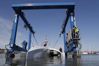 FILE - In this Monday, Sept. 14, 2020 file photo, technicians lower the Mayflower Autonomous Ship into the water at its launch site for it's first outing on water since being built in Turnchapel, Plymouth south west England. Four centuries and one year after the Mayflower departed from Plymouth, England on a historic sea journey to America, another trailblazing vessel with the same name has set off to retrace the voyage. It’s being piloted by sophisticated artificial intelligence technology for a trans-Atlantic crossing that could take up to three weeks, in a project aimed at revolutionizing marine research. IBM, which built the ship with nonprofit marine research organization ProMare, confirmed the Mayflower Autonomous Ship began its trip early Tuesday June 15, 2021.(AP Photo/Alastair Grant, file)