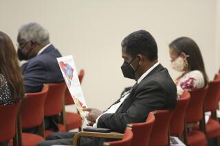 South Carolina Rep. Jerry Govan, D-Orangeburg, looks over a map during a House redistricting committee public hearing on Wednesday, Nov. 10, 2021, in Columbia, S.C. Govan was put into a district with another incumbent in the proposed House map. (AP Photo/Jeffrey Collins)