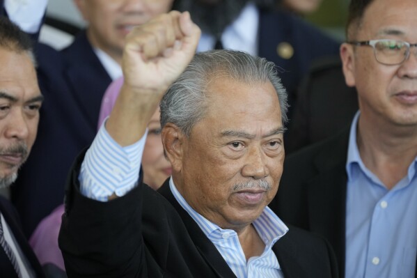 FILE - Malaysia's former Prime Minister Muhyiddin Yassin poses for media outside courthouse, after charged with corruption and money laundering, in Kuala Lumpur, Malaysia, on March 10, 2023. Muhyiddin was acquitted by the high court of four corruption charges on Tuesday, Aug. 15, just days after his opposition bloc expanded its influence in local elections. (AP Photo/Vincent Thian, File)