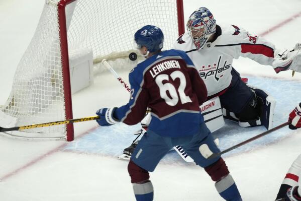 Colorado Avalanche left wing Artturi Lehkonen, front, looks on as his shot sails past Washington Capitals goaltender Darcy Kuemper for a goal in the first period of an NHL hockey game Tuesday, Jan. 24, 2023, in Denver. (AP Photo/David Zalubowski)