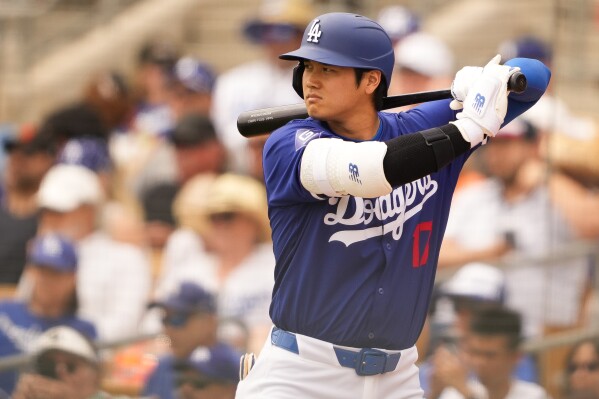 Los Angeles Dodgers designated hitter Shohei Ohtani waits on deck against the San Francisco Giants during the third inning of a spring training baseball game Tuesday, March 12, 2024, in Phoenix. (AP Photo/Lindsey Wasson)