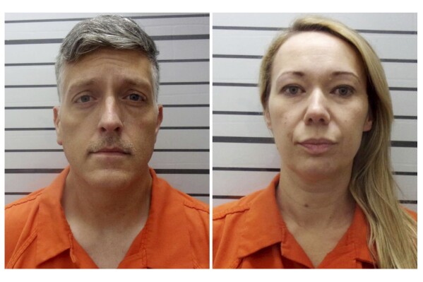 FILE - This combination of booking photos provided by the Muskogee County, Okla., Sheriff's Office shows Jon Hallford, left, and Carie Hallford, the owners of Return to Nature Funeral Home. The couple who owned the Colorado funeral home — where 190 decaying bodies were discovered last year — have been indicted on federal charges for fraudulently obtaining nearly $900,000 in pandemic relief funds from the U.S. government, according to court documents unsealed Monday, April 15, 2024. (Muskogee County Sheriff's Office via AP, File)