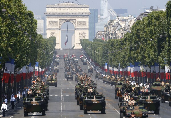 FILE - French VAB armored personnel carriers, front rows from left, attend the Bastille Day parade in Paris, July 14, 2013. French Defense Minister Sébastien Lecornu said France is going to deliver “hundreds” of armored vehicles by the beginning of next year to Ukraine. (AP Photo/Francois Mori, File)