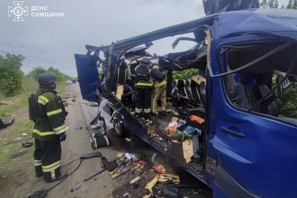 In this photo provided by the Ukrainian Emergency Service, rescuers recover the bodies of passengers after a Russian drone struck a passenger bus at the village of Bilopillya in the Sumy region, Ukraine, Saturday, May 17, 2025. (Ukrainian Emergency Service via AP)