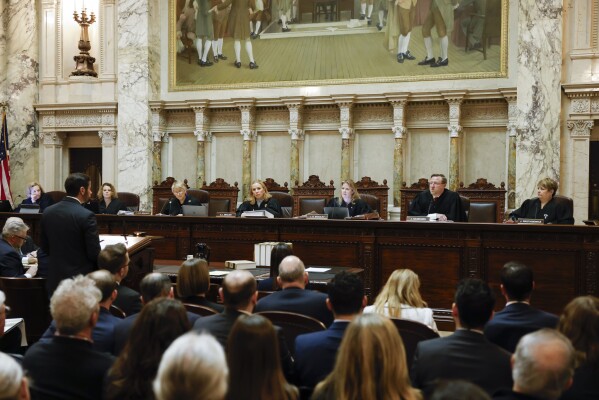 FILE - The Wisconsin Supreme Court listens to arguments from Wisconsin Assistant Attorney General Anthony D. Russomanno, representing Gov. Tony Evers, during a redistricting hearing at the state Capitol, Nov. 21, 2023, in Madison, Wis. The liberal-controlled Wisconsin Supreme Court overturned Republican-drawn legislative maps on Friday, Dec. 22, and ordered that new district boundary lines be drawn as Democrats had urged in a redistricting case they hope will weaken GOP majorities. (Ruthie Hauge/The Capital Times via AP, Pool, File)