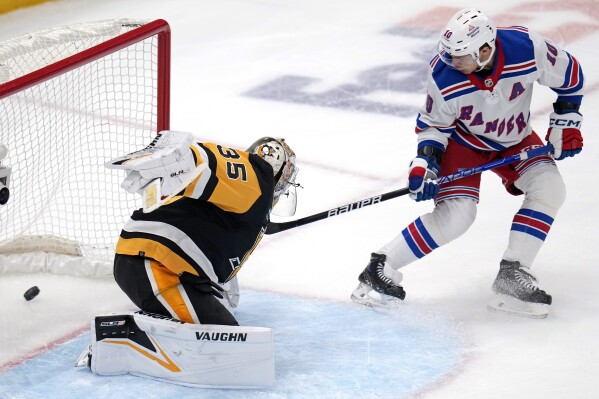 New York Rangers' Artemi Panarin (10) backhands a shot past Pittsburgh Penguins goaltender Tristan Jarry (35) for a goal during the first period of an NHL hockey game in Pittsburgh, Saturday, March 16, 2024. (AP Photo/Gene J. Puskar)