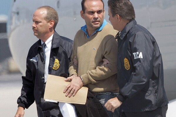 FILE - Colombian paramilitary warlord Salvatore Mancuso is escorted by U.S. DEA agents upon his arrival to Opa-locka, Florida, May 13, 2008. Florida Republican Sen. Marco Rubio called on the Biden administration Wednesday, Aug. 23, 2023, to reject Colombia's request for extradition of Mancuso after he was named a peace envoy in the South American nation. (AP Photo/Alan Diaz, File)