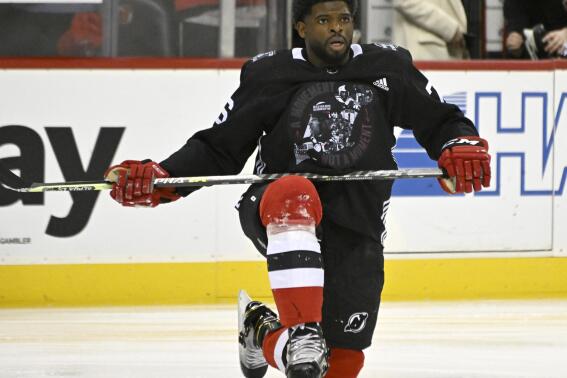 FILE - New Jersey Devils defenseman P.K. Subban stretches before the team's NHL hockey game against the Vancouver Canucks, Monday, Feb. 28, 2022, in Newark, N.J. The Devils wore warmup jerseys designed by Subban for Black History Month. Subban retired from the NHL a year ago at age 33 to go into broadcasting. Now he’s got a new show with Peyton Manning’s Omaha Productions called “P.K.’s Places." It's the latest chance for the Black former star to be one of the faces of hockey on ESPN and another show of diversity for a sport trying to grow in the U.S. beyond a predominantly white audience. (AP Photo/Bill Kostroun, File)
