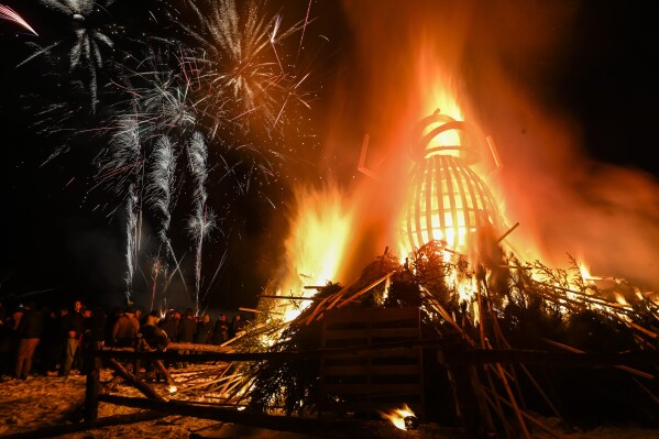 Fireworks go off while the beetle goes up in flames after being set on fire during the 11th annual Burning Beetle event on Saturday, Jan. 20, 2024, at Pageant Park in Custer, S.D. The event was created in response to the Mountain Pine Beetle infestation a few years ago and continues to bring awareness to the impact of the beetles. (Matt Gade/Rapid City Journal via AP)