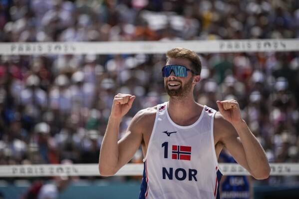 Norway's Anders Berntsen Mol celebrate victory in the men's round of 16 beach volleyball match between USA and Norway at Eiffel Tower Stadium at the 2024 Summer Olympics, Monday, Aug. 5, 2024, in Paris, France. (AP Photo/Louise Delmotte)