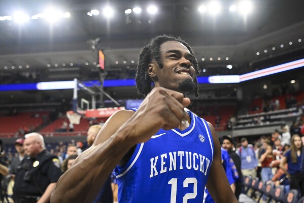 Kentucky guard Antonio Reeves (12) celebrates the team's win over Auburn in an NCAA college basketball game Saturday, Feb. 17, 2024, in Auburn, Ala. (AP Photo/Julie Bennett)