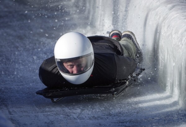 Prince Harry, Duke of Sussex, hits a wall as he slides down the track on a skeleton sled during an Invictus Games training camp, in Whistler, British Columbia, Thursday, February 15, 2024. The Invictus Games Vancouver Whistler 2025 is scheduled to be held February 8-16, 2025 It will include winter sports for the first time.  (Darryl Dyke/The Canadian Press via AP)