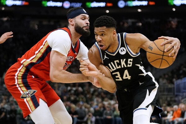 Milwaukee Bucks' Giannis Antetokounmpo (34) drives to the basket against New Orleans Pelicans' Larry Nance Jr. during the first half of an NBA basketball game Saturday, Jan. 27, 2024, in Milwaukee. (AP Photo/Aaron Gash)