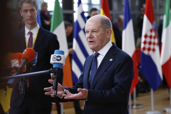Germany's Chancellor Olaf Scholz speaks with the media as he arrives for an EU Summit at the European Council building in Brussels, Thursday, March 6, 2025. (AP Photo/Omar Havana)