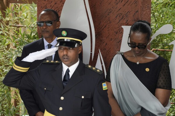 Rwandan President Paul Kagame, background left and his wife, first lady Jeannette Kagame prepare to lay a wreath, during a ceremony to mark the 30th anniversary of the Rwandan genocide, held at the Kigali Genocide Memorial, in Kigali, Rwanda, Sunday, April 7, 2024. Rwandans are commemorating 30 years since the genocide in which an estimated 800,000 people were killed by government-backed extremists, shattering this small east African country that continues to grapple with the horrific legacy of the massacres. (AP Photo/Brian Inganga)
