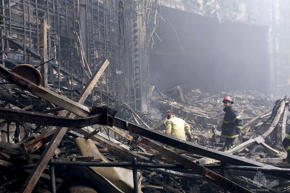 In this photo released by Russian Emergency Ministry Press Service on Saturday, March 23, 2024, firefighters work in the burned concert hall after an attack on the building of the Crocus City Hall on the western edge of Moscow, Russia. (Russian Emergency Ministry Press Service via AP)