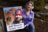 Lynn Wenkes of Wrentham, Mass., holds a photo of her son Jeff as she sits in the garden of her home on Tuesday, Nov. 7, 2023.  The Wenkes lost Jeff in 2017 to a heroin overdose.  Families who lost loved ones to overdoses are at odds over OxyContin maker Purdue Pharma's plan to settle lawsuits over the toll of opioids with governments.  It could provide billions of dollars to combat the extreme pandemic and pay some victims.  But it would also protect members of the Sackler family, which owns the company, from future lawsuits.  (AP Photo/Steven Sene)