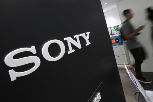 FILE - Visitors walk past a logo of Sony at Sony Building in Tokyo, July 31, 2014. Sony’s quarterly profit through September rose 24% on healthy demand for its music and movies, prompting the Japanese entertainment and electronics company to raise its annual sales and profit forecasts Tuesday, Nov. 1, 2022. (AP Photo/Eugene Hoshiko, File)
