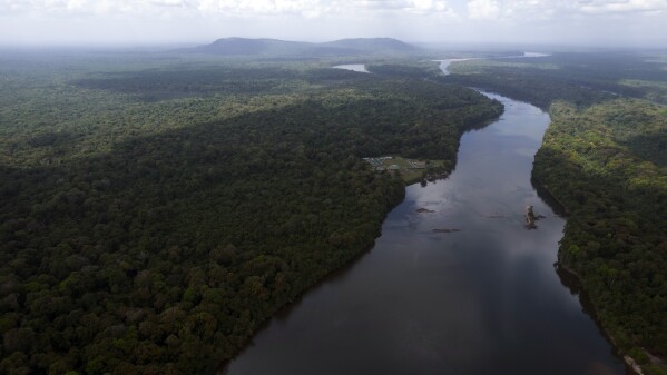 FILE - The Essequibo River flows through Kurupukari crossing in Guyana, Nov. 19, 2023. Venezuela has long claimed Guyana's Essequibo region, a territory larger than Greece and rich in oil and minerals. On Sunday, Dec. 10, the government of Guyana, under pressure from neighboring Brazil and a Caribbean trading bloc, agreed to join bilateral talks with Venezuela over an escalating territorial dispute. (AP Photo/Juan Pablo Arraez, File)