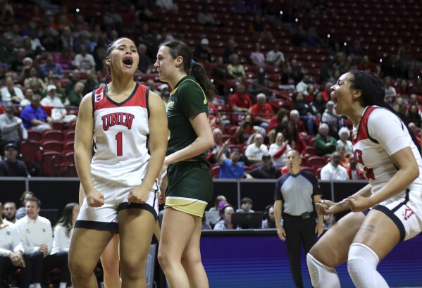 UNLV forward Nneka Obiazor (1) celebrates with teammate forward Alyssa Brown, right, after scoring a basket and drawing a foul in the first half of an NCAA college basketball game in the semifinals of the Mountain West Conference tournament, Tuesday, March 12, 2024, in Las Vegas. (Steve Marcus/Las Vegas Sun via AP)