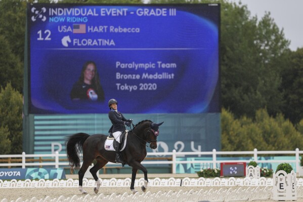 Rebecca Hart of the U.S. competes in the equestrian grade III individual event at the Palace of Versailles, taking home the gold medal at the 2024 Paralympics, Tuesday, Sept. 3, 2024. (AP Photo/Kileigh Kane)
