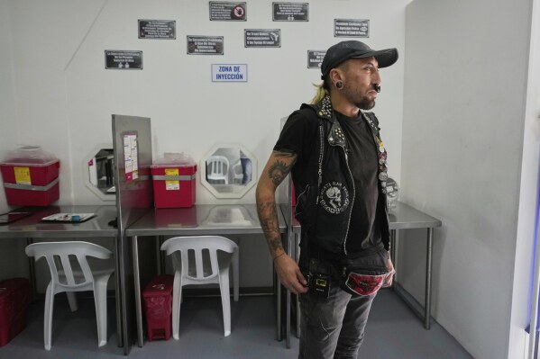 Christian Amaya, a drug user, looks out the window of the Cambie supervised consumption room in Bogotá, Colombia, Sunday, April 27, 2025, where people who use substances receive injection kits or bring their own drugs while learning safe practices. (AP Photo/Fernando Vergara)