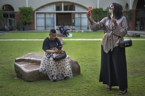 Fashionistas wait for the start of Johannesburg Fashion Week 2023 in Johannesburg, South Africa, Wednesday, Nov. 8, 2023. (AP Photo/Jerome Delay)