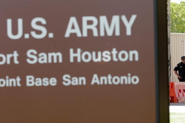 FILE - A guard stands at a gate to Fort Sam Houston, Monday, June 10, 2013, in San Antonio. Lt. Col. Mark Patterson, a New Hampshire National Guard officer who led a battalion on the southern U.S. border has pleaded guilty to assault and several other crimes and been sentenced to a reprimand, according to the U.S. Army, Wednesday, Jan. 24, 2024. The investigation concluded in May and led the court-martial at Joint Base San Antonio–Fort Sam Houston in which Patterson pleaded guilty. (AP Photo/Eric Gay, File)