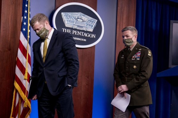 Secretary of the Army Ryan McCarthy, left, and Gen. James McConville, Chief of Staff of the Army, right, depart after speaking at a briefing on an investigation into Fort Hood, Texas at the Pentagon, Tuesday, Dec. 8, 2020, in Washington. The Army says it has fired or suspended 14 officers and enlisted soldiers at Fort Hood, Texas, and ordered policy changes to address chronic leadership failures at the base that contributed to a widespread pattern of violence including murder, sexual assaults and harassment. (AP Photo/Andrew Harnik)