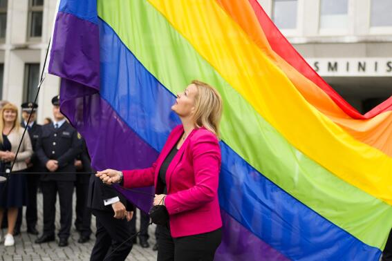 FILE - German interior Minister Nancy Faeser raises the rainbow flag for the first time at the German Interior Ministry in Berlin, Germany, on May 17, 2022. Qatar has summoned the German ambassador over remarks by Germany’s interior minister, who appeared to criticize the decision to award the World Cup to the Gulf Arab nation because of its human rights record. (AP Photo/Markus Schreiber, File)