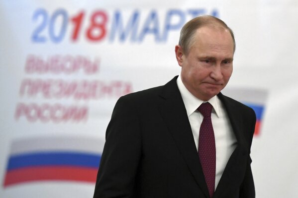 
              Russian President and Presidential candidate Vladimir Putin arrives to vote at a polling station during Russia's presidential election in Moscow, Russia, Sunday, March 18, 2018. Putin's victory in Russia's presidential election Sunday isn't in doubt. The only real question is whether voters will turn out in big enough numbers to hand him a convincing mandate for his fourth term, and many Russian workers are facing intense pressure to do so. (Yuri Kadobnov/Pool Photo via AP)
            