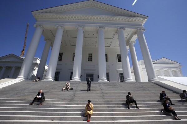 FILE - House of Delegates members eat boxed lunches on the steps of the Virginia Capitol, April 22, 2020, in Richmond, Va. Virginia lawmakers will reconvene in Richmond on Wednesday, Sept. 6, 2023, to consider a compromise General Assembly negotiators recently reached on the long-delayed state budget. (Bob Brown/Richmond Times-Dispatch via AP, Pool, File)