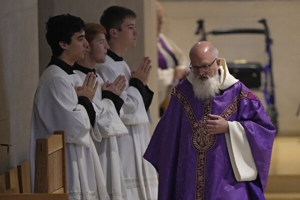 Rev. Gabriel Landis officiates a Catholic Mass at Benedictine College Sunday, Dec. 3, 2023, in Atchison, Kan. (AP Photo/Charlie Riedel)