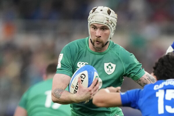 FILE - Ireland's Mack Hansen races to score a try during the Six Nations rugby union international match between Italy and Ireland, at Rome's Olympic Stadium, Saturday, Feb. 25, 2023. Ireland winger Mack Hansen will miss his team’s Six Nations title defense after dislocating his shoulder. (AP Photo/Andrew Medichini, File)