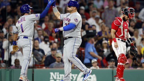 New York Mets' Daniel Vogelbach (32) celebrates his two-run home run that also drove in Jeff McNeil (1) behind Boston Red Sox's Connor Wong during the fourth inning of a baseball game, Friday, July 21, 2023, in Boston. (AP Photo/Michael Dwyer)