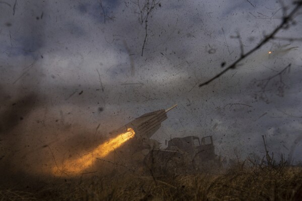 A Ukrainian MSLR BM-21 "Grad" of 95 Air Assault brigade fires towards Russian positions at the frontline near Kreminna, Ukraine, March 9, 2023. (AP Photo/Evgeniy Maloletka)