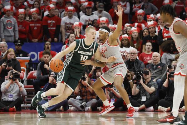 Michigan State's Joey Hauser, left, posts up against Ohio State's Roddy Gayle during the second half of an NCAA college basketball game on Sunday, Feb. 12, 2023, in Columbus, Ohio. (AP Photo/Jay LaPrete)