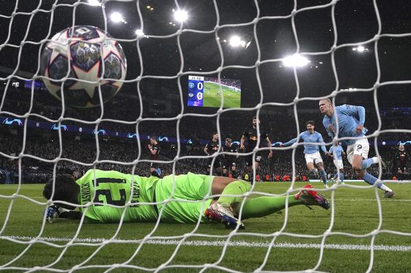 Manchester City's Erling Haaland scores his side's first goal of the game during the Champions League round of 16 second leg soccer match between Manchester City and RB Leipzig at the Etihad stadium in Manchester, England, Tuesday, March 14, 2023. (Nick Potts/PA via AP)