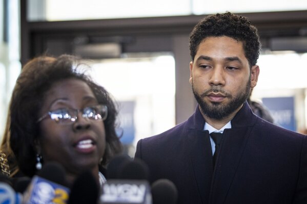 
              Actor Jussie Smollett, right, listens as his attorney, Patricia Brown Holmes, speaks to reporters at the Leighton Criminal Courthouse after prosecutors dropped all charges against him on Tuesday, March 26, 2019. (Ashlee Rezin/Sun-Times/Chicago Sun-Times via AP)
            