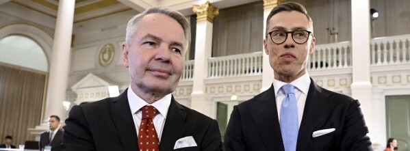 Leaders after the early vote results, National Coalition Party candidate Alexander Stubb, right, and Social Movement candidate Pekka Haavisto stand during the Presidential election event, at the Helsinki City Hall, in Helsinki, Finland, Sunday, Jan. 28, 2024. ( (Markku Ulander/Lehtikuva via AP)